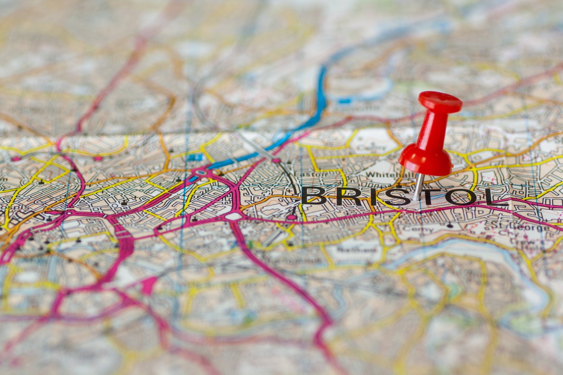 Paper road map with thumbtack marking Bristol